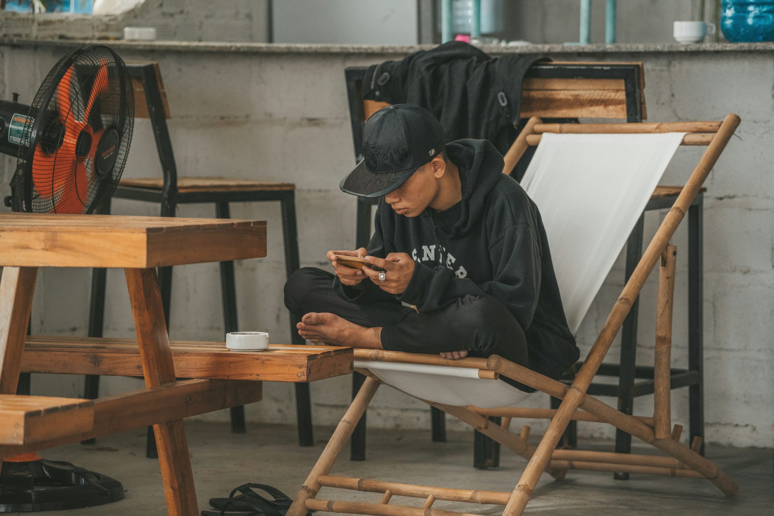 Person sitting cross-legged while using a smartphone app
