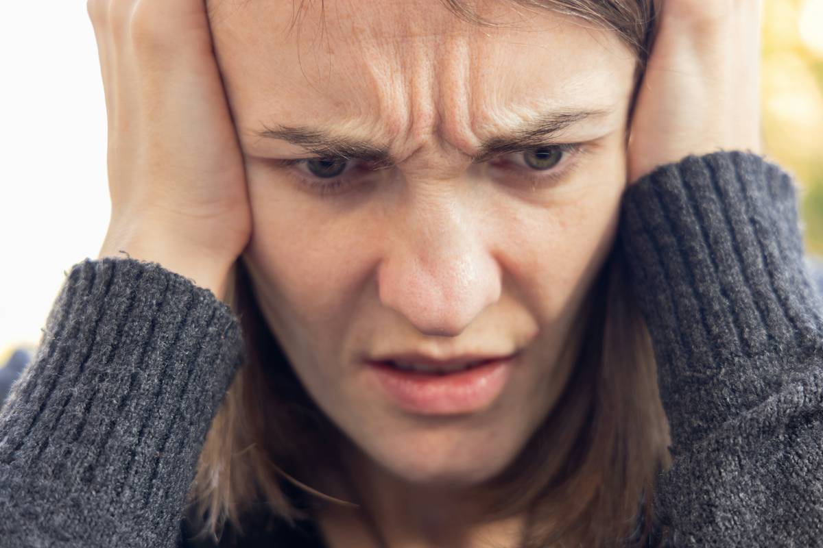 A person sitting at their desk looking overwhelmed