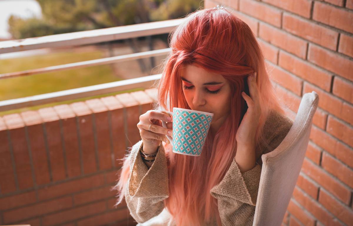 Woman sitting on bed looking stressed in the evening